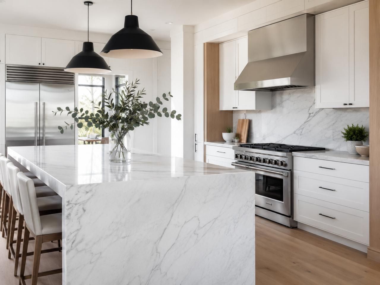 Bright modern kitchen with marble island and stainless steel appliances